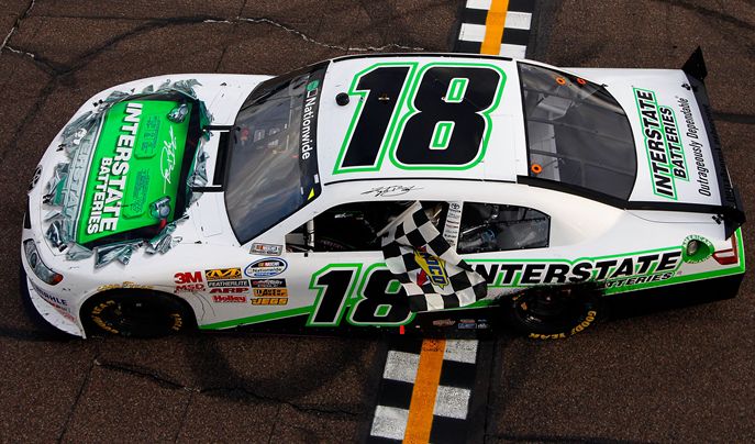 Kyle Busch drives to Victory Lane with the checkered flag after winning the Bashas' Supermarkets 200 at Phoenix International Raceway. Credit: Tom Pennington/Getty Images for NASCAR